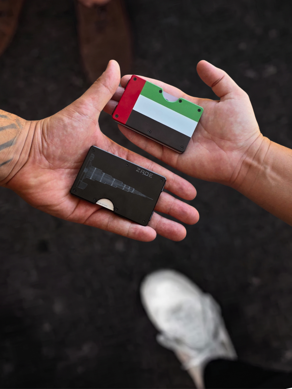 Two Zade wallets, UAE flag and Burj Khalifa editions, held in open hands
