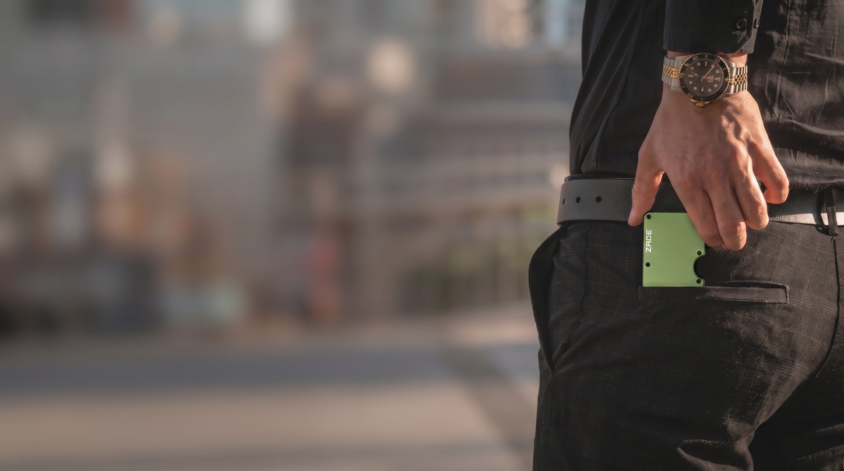 Zade olive green wallet in pocket, man walking city street with luxury watch